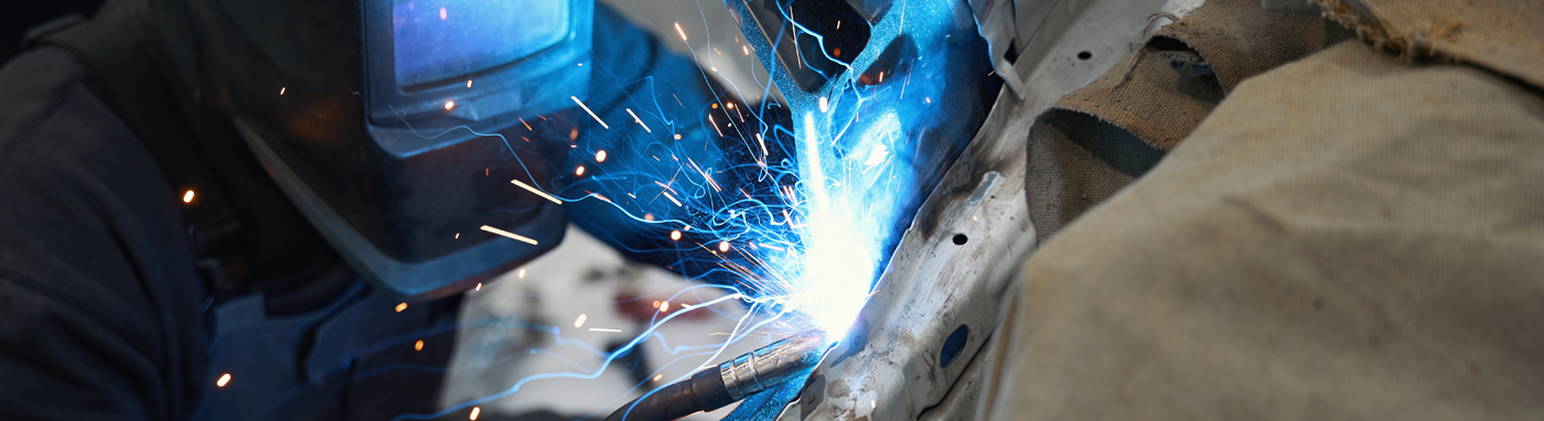 Auto Body and Collision Repair in Clio MI | Auto body repair technician restoring vehicle damage at Simms Body Shop Simms Body Shop collision repair facility in Clio MI
